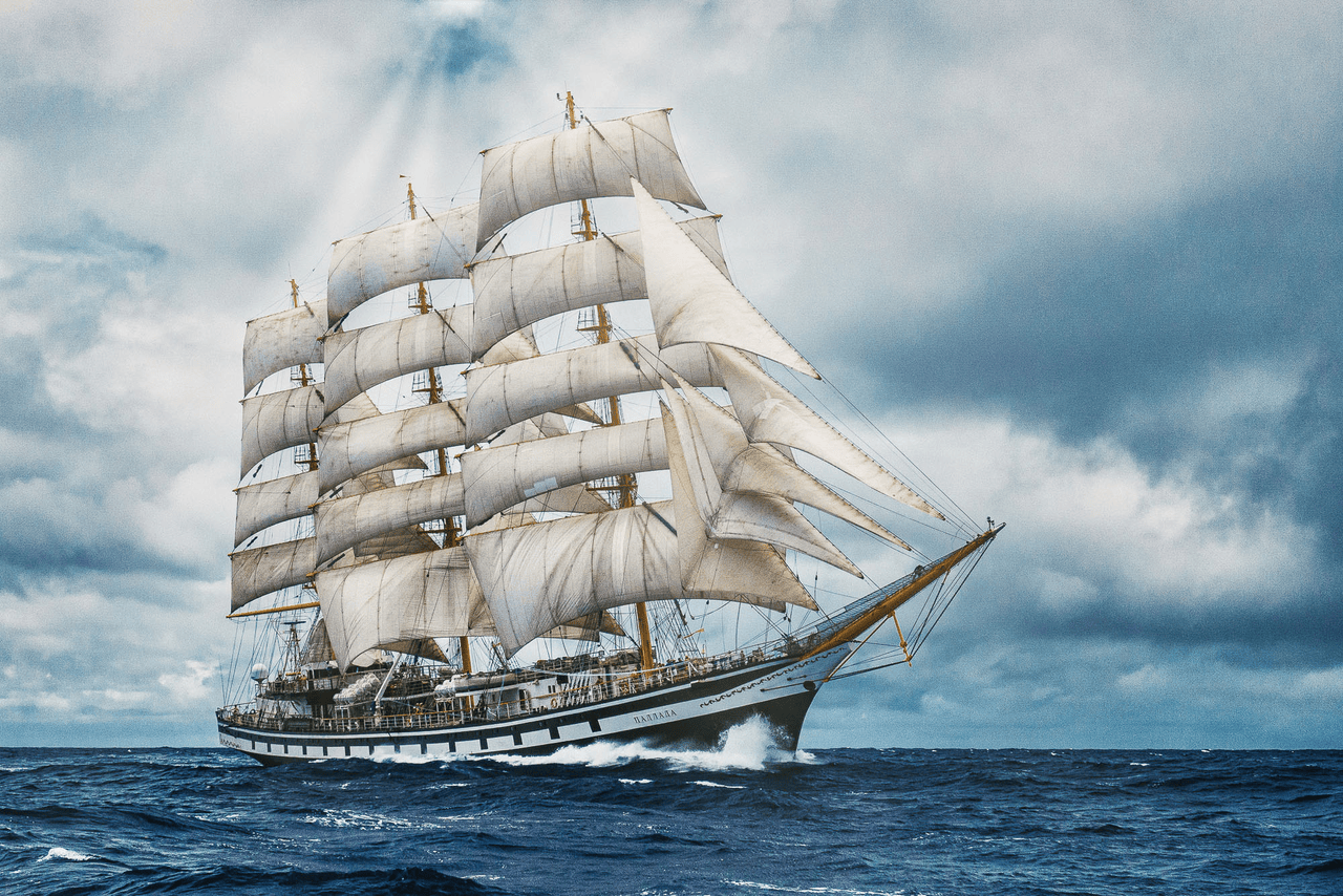 A galleon at full sail in the open sea. A god ray shines down on the ship from a cloud above.